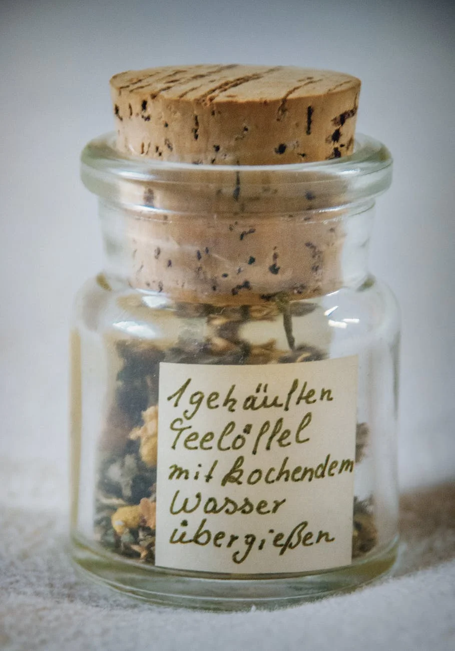 paper inside clear glass jar with brown cork