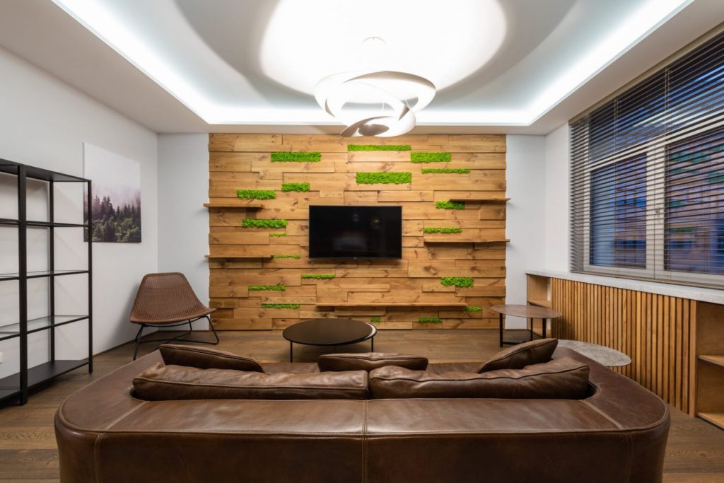 luxury lounge with leather sofa and tv hanging on wall