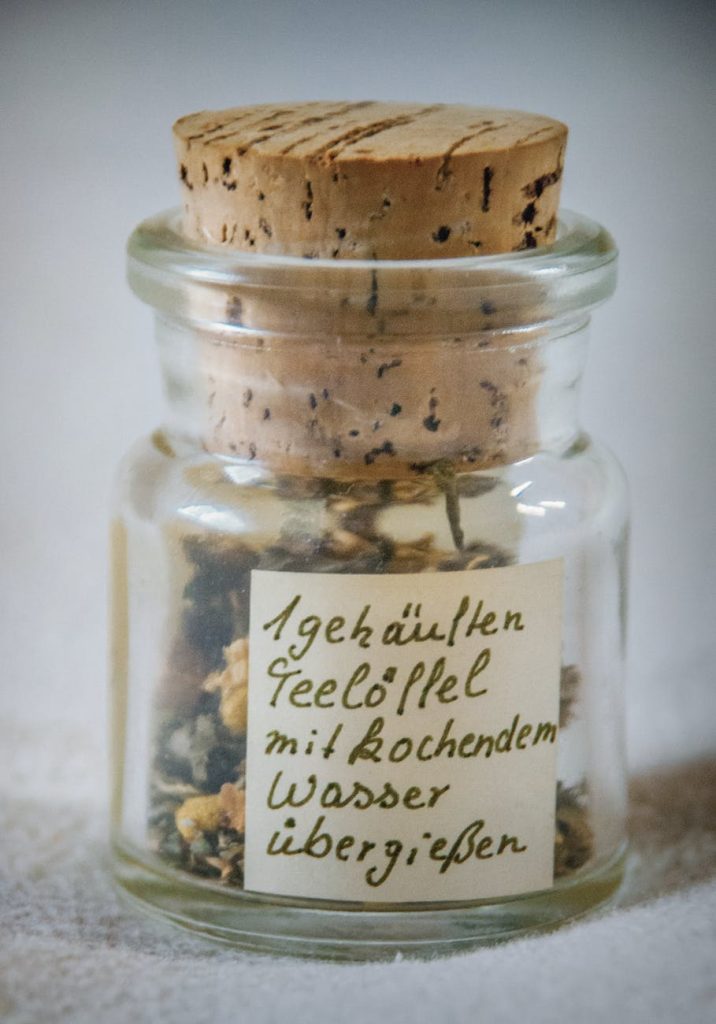 paper inside clear glass jar with brown cork